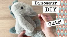 someone is holding a stuffed animal with the words dinosaur diy cut out on it