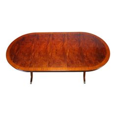 an oval wooden table with two legs and a leaf design on the top, against a white background