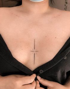 a woman with a cross tattoo on her chest