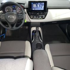 the interior of a car with dashboard, steering wheel and display screen showing information about vehicles