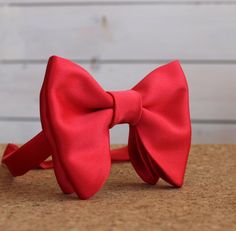 "Oversized Bow Tie in Bright Red Satin. Pre-tied and adjustable strap. Bow tie size - Width: 12 cm /4,7\" | Height: 10 cm / 3.93'' The adjustable strap takes it to 21\" in length, making it a great accessory that can be adjusted for comfort and fit or given as a gift if you are unsure of neck size. Perfect for formal or causal use. **bowties are shipped in a small shipping box to keep them from being damaged" Red Adjustable Bow Tie With Bow Tie Back, Adjustable Red Bow Tie With Bow Tie Back, Adjustable Red Bow Tie For Wedding, Red Satin Bow Tie Adjustable, Adjustable Red Satin Bow Tie, Red Satin Standard Bow Tie, Adjustable Red Satin Bow, Classic Adjustable Red Bow, Red Bow Tie For Formal Occasions