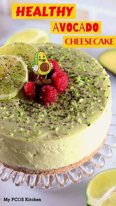 a close up of a cake with raspberries and limes on the top