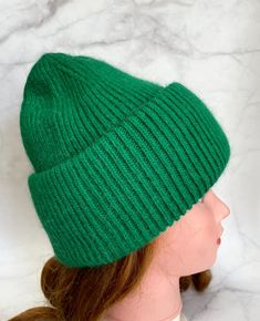 a green knitted hat on top of a mannequin head