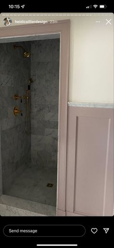 an open shower door in a bathroom next to a wall with marble tiles on it