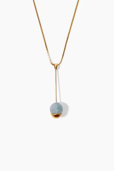 A gold-dipped aquamarine sphere suspends from a slim gold bar giving unexpected balance to this pendant necklace. A serpentine chain completes the look. 18k gold plated sterling silver. 16" - 18" Adjustable. Handmade in Vietnam. Blue Pendant Necklace, Large Pendant Necklace, Aquamarine Pendant, Thread Earrings, Blue Pendant, Pink Necklace, Diamond Star, White Necklace, Latest Jewellery