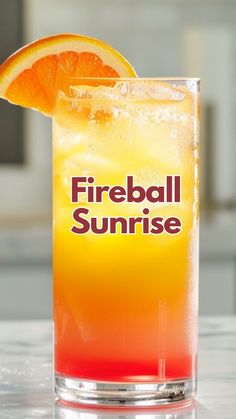 a fireball sunrise cocktail with an orange slice on the rim