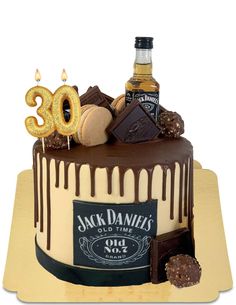 a 30th birthday cake with chocolate icing and candies on the top is decorated with an image of jack daniels