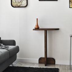 a living room with three framed pictures on the wall