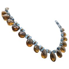 One-of-a-Kind A unique and beautiful cut of Whiskey Quartz necklace. Quartz cognac faceted drops separated by small faceted blue Topaz spacers as well as vermeil and CZ roundels are combined in an unusually pleasing and flattering color combination. The clasp is a Topaz brown glass intaglio. Silk hand-knotted Approx:19 inch Bracelet Love, Topaz Necklace, Gio Ponti, Quartz Necklace, Baccarat, Hermes Birkin, Blue Topaz, Cartier, Cognac