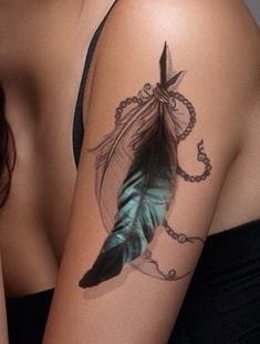 a woman with a feather tattoo on her arm