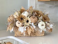 a basket filled with lots of white and brown flowers