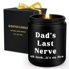 a candle that is next to a box with a ribbon on it and the words dad's last nerve