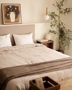 a bed with white sheets and pillows in a bedroom