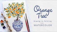 an orange tree is painted with watercolors on a white paper next to some paintbrushes