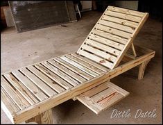 a bed made out of wooden planks sitting on top of a cement floor in a garage