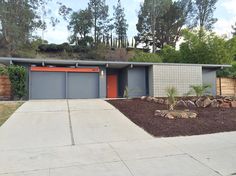 a modern house with an orange garage door