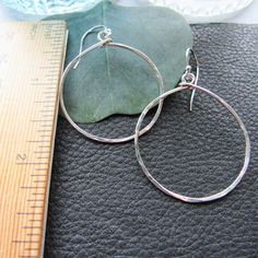 Bright hammered sterling silver will shimmer in the sunlight. A fun take on a hoop, these earrings are sure to become a classic in your wardrobe.Hoop is just over 1" and 1.50" long from top of the ear wire to the bottom. Everyday Small Hoop Hammered Earrings, Adjustable Sterling Silver Hoop Earrings With Lever Back, Small Hammered Hoop Earrings, Everyday Sterling Silver Hammered Hoop Earrings, Hammered Adjustable Small Hoop Earrings, Adjustable Hammered Dangle Hoop Earrings, Small Hammered Adjustable Hoop Earrings, Adjustable Hammered Hoop Earrings, Hammered Dangle Hoop Earrings