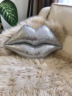 a white couch with silver glitter lips on it