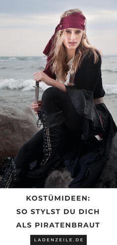 a woman sitting on top of a rock next to the ocean