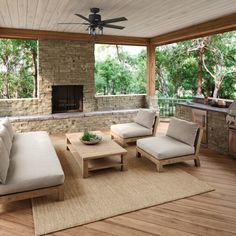 a living room with couches, tables and a ceiling fan