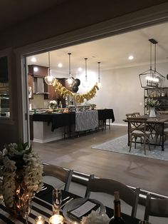 a dining room table and chairs are set up for a formal dinner with candles on it