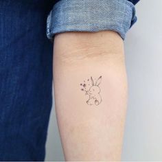 a person with a small tattoo on their arm