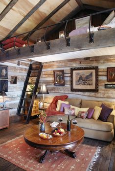 a living room filled with furniture and wooden walls