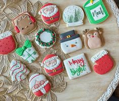 decorated christmas cookies sitting on top of a table