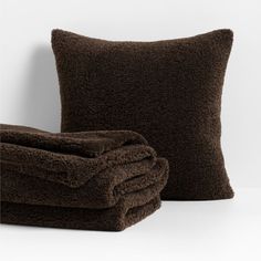 two brown pillows sitting next to each other