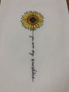 a sunflower embroidered onto a white napkin