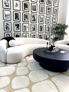 a living room filled with furniture and pictures on the wall