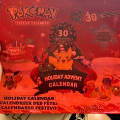 the pokemon festive calendar is being held in someone's hand