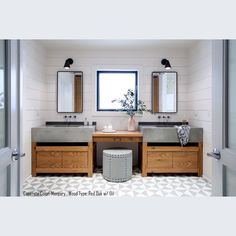 a bathroom with two sinks and mirrors on the wall