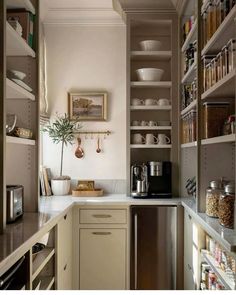 a kitchen with lots of shelves and cabinets