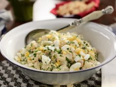 a white bowl filled with food on top of a table