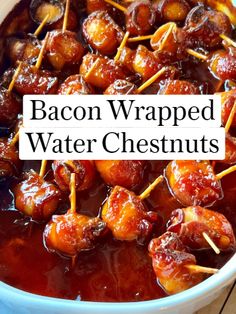 bacon wrapped water chestnuts with toothpicks in a blue bowl on a wooden table