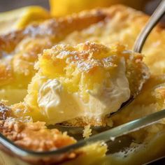 a close up of a dessert in a glass dish with a spoon sticking out of it