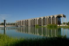 a large building sitting next to a body of water