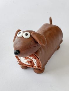 a cake shaped like a dog with googly eyes on it's face and tail