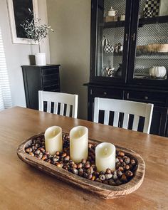 two candles are sitting on a tray with rocks