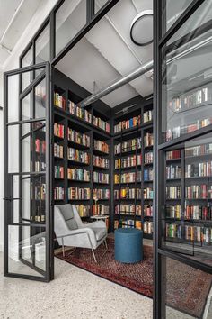 a room with lots of books on the shelves and a chair in front of it