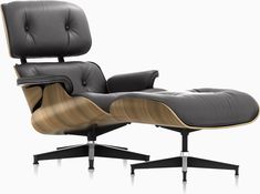 the eames chair and ottoman is shown in black leather with wood trimmings