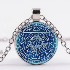 a blue pendant with an intricate design on it