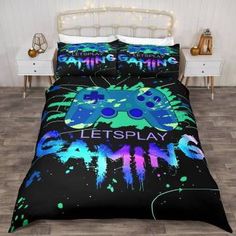 a bed with a video game themed comforter and matching pillow cases on top of it