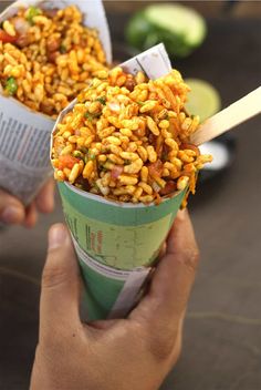 two people holding ice cream cones filled with food