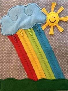 there is a rainbow with a cloud and sun on the top of it, as well as some zippers