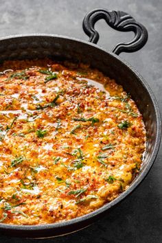 a large skillet filled with food on top of a table