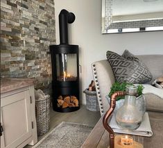 a living room filled with furniture and a fire place in the middle of the room