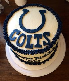 a cake with the word colts on it is sitting on top of a wooden table