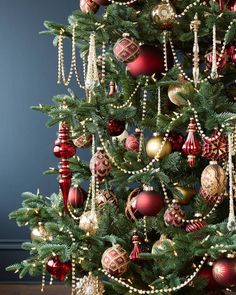 a christmas tree decorated with red and gold ornaments